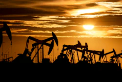 In this Feb. 2, 2020 photo, pump jacks operate in an oilfield as the sun begins to set on the horizon in Midland, Texas.