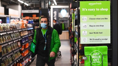 The Amazon Fresh grocery store opens in London, Thursday March 4, 2021, where a sign explains for shoppers to pick up items and walk out of the store, contactless, without the need for a till. Customers will scan a QR code on their way into the store, with cameras and technology identifying the items that shoppers take from the shelves and their account automatically paid.