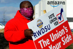 Michael Foster of the Retail, Wholesale and Department Store Union holds a sign outside an Amazon facility where labor is trying to organize workers on Tuesday, Feb. 9, 2021. President Joe Biden said workers in Alabama and across the country have the right to join a union without intimidation from their companies. His comments come as Amazon workers in the state are voting on whether they should unionize. In a two minute video posted to Twitter, Biden didn’t mention Amazon by name, or say how workers should vote.