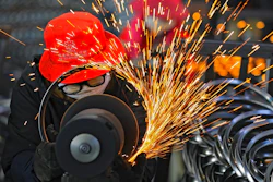 In this Feb. 19, 2021, file photo, workers wearing face masks polish bicycle wheel rims at a factory in Hangzhou in east China's Zhejiang province. China’s factory activity rebounded in March from a three-month slowdown as export orders rose, a survey showed Wednesday, March 31, 2021.