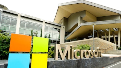 In this July 3, 2014, file photo, the Microsoft Corp. logo is displayed outside the Microsoft Visitor Center in Redmond, Wash. Microsoft will begin bringing workers back to its suburban Seattle global headquarters on March 29, 2021, as the tech giant starts to reopen more facilities it largely shuttered during the coronavirus pandemic.