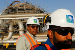 In this Sept. 20, 2019, file photo, engineers walk in front of an oil separator at a Saudi Aramco processing facility in Abqaiq, Saudi Arabia. Saudi Arabia's state-backed oil giant Aramco announced Sunday, March 21, 2021, that its 2020 profits fell sharply in 2020 to $49 billion, a big drop that came as the coronavirus pandemic roiled global energy markets.