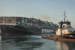 In this photo released by Suez Canal Authority, the Ever Given, a Panama-flagged cargo ship, is pulled by one of the Suez Canal tugboats.