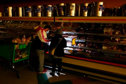 Texans shop in a dark supermarket after one of the worst blackouts in state history, February 2021.