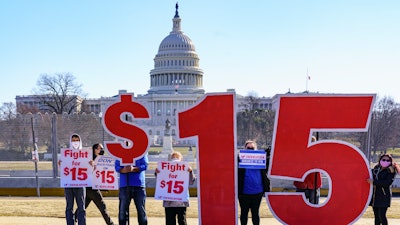 Activists appeal for a $15 minimum wage near the Capitol in Washington, Thursday, Feb. 25, 2021.