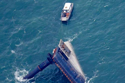 A rescue boat is seen next to the capsized lift boat Seacor Power seven miles off the coast of Louisiana in the Gulf of Mexico Sunday, April 18, 2021. The vessel capsized during a storm on Tuesday.