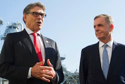 In this Thursday, July 26, 2018 file photo, Secretary of Energy Rick Perry, left, with the main cyrogenic heating exchange behind him, and Thomas Farrell, II, chairman, president and CEO, Dominion Energy, speak with reporters at Dominion Energy's Cove Point LNG liquefaction Project facility in Lusby, Md., Tom Farrell, who led Dominion Energy for more than a decade, has died Friday, April 2, 2021 one day after he stepped down from his post. He was 66.