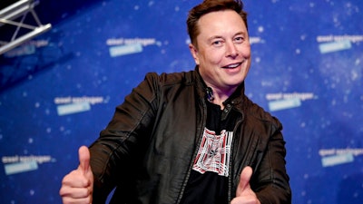 In this Tuesday, Dec. 1, 2020 file photo, SpaceX owner and Tesla CEO Elon Musk arrives on the red carpet for the Axel Springer media award, in Berlin, Germany. Technology mogul Elon Musk has a lined up a new gig in addition to his jobs as CEO of electric car maker Tesla and spaceship maker SpaceX. He is going to host the iconic TV show “Saturday Night Live ' on May 8, 2021.
