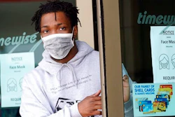 A man leaves a convenience store while wearing a required face mask in Houston, in this Thursday, June 25, 2020, file photo. Although nearly a fifth of U.S. states don't require people to wear masks to protect against COVID-19, some businesses are requiring employees and customers to be masked on their premises.