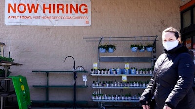 A hiring sign is seen outside home improvement store in Mount Prospect, Ill., Friday, April 2, 2021. The pace of job openings reached the highest level on record in February, a harbinger of healthy hiring and a hopeful sign for those looking for work.