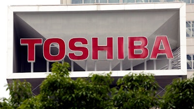 This May 26, 2017 file photo shows the company logo of Toshiba Corp. displayed in front of its headquarters in Tokyo.Trading in Toshiba stock was halted Wednesday, April 7, 2021 after the Tokyo-based technology conglomerate confirmed it had received a preliminary acquisition proposal. Toshiba Corp. said Tuesday, April 6 it had asked for more details on the proposal, was giving it “careful consideration” and would make an announcement “in due course.”