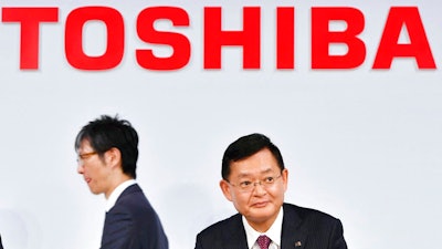 In this November 2018, photo, then Toshiba Corp., Chairman and CEO Nobuaki Kurumatani gets out of a seat after a press conference in Tokyo. Kurumatani stepped down Wednesday, April 14, 2021, a week after the Japanese technology and manufacturing conglomerate said it was studying an acquisition proposal from a global fund where he previously worked. Kurumatani tendered his resignation at a board meeting, and the board accepted, effective Wednesday, Tokyo-based Toshiba said in a statement.