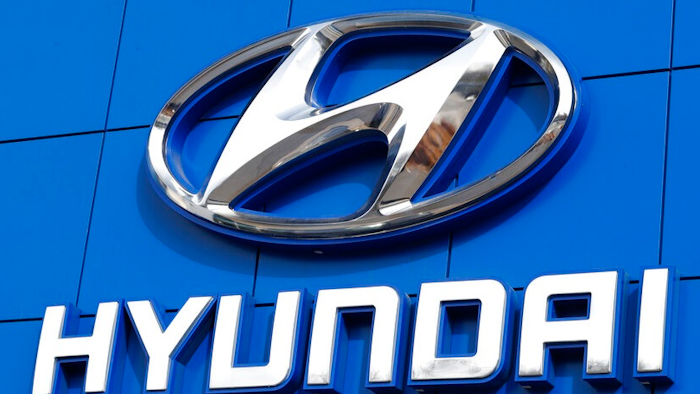 This July 26 2018 file photo shows the logo of Hyundai Motor Co. in Seoul, South Korea. Hyundai is recalling over 390,000 vehicles in the U.S. and Canada, Tuesday, May 4, 2021, for problems that can cause engine fires. In one recall, owners are being told to park outdoors until repairs are made. That recall covers more than 203,000 Santa Fe Sport SUVs from 2013 through 2015.