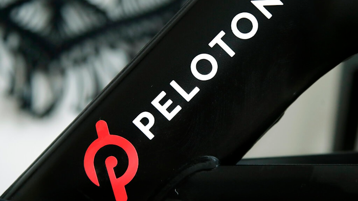 This Nov. 19, 2019 file photo shows a Peloton logo on the company's stationary bicycle in San Francisco. Peloton is recalling its treadmills after one child died and 29 other children suffered from cuts, broken bones and other injuries from being pulled under the rear of the treadmill. The U.S. Consumer Product Safety Commission said Wednesday, May 5, 2021, that Peloton received 72 reports of adults, kids, pets or other items, such as exercise balls, being pulled under the treadmill.