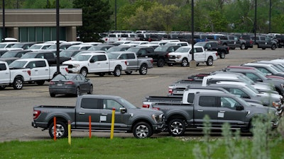 Ford pickup trucks built lacking computer chips are shown in parking lot storage in Dearborn, Mich., Tuesday, May 4, 2021. Automakers are cutting production as they grapple with a global shortage of computer chips, and that's making dealers nervous.