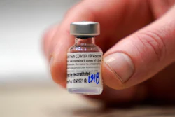 This Jan. 24, 2021, file photo shows a vial of the Pfizer vaccine for COVID-19 in Seattle. U.S. regulators on Monday, May 10, 2021, expanded use of Pfizer's shot to those as young as 12, sparking a race to protect middle and high school students before they head back to class in the fall.