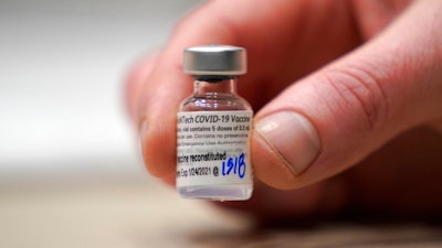 This Jan. 24, 2021, file photo shows a vial of the Pfizer vaccine for COVID-19 in Seattle. U.S. regulators on Monday, May 10, 2021, expanded use of Pfizer's shot to those as young as 12, sparking a race to protect middle and high school students before they head back to class in the fall.