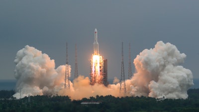 In this April 29, 2021, file photo released by China's Xinhua News Agency, a Long March 5B rocket carrying a module for a Chinese space station lifts off from the Wenchang Spacecraft Launch Site in Wenchang.