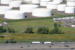 In this Sept. 8, 2008 file photo traffic on I-95 passes oil storage tanks owned by the Colonial Pipeline Company in Linden, N.J. A major pipeline that transports fuels along the East Coast says it had to stop operations because it was the victim of a cyberattack. Colonial Pipeline said in a statement late Friday that it “took certain systems offline to contain the threat, which has temporarily halted all pipeline operations, and affected some of our IT systems.”