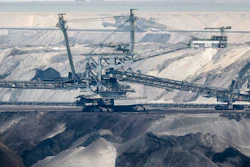 In this Thursday, April 29, 2021 file photo, giant bucket-wheel excavators extract coal at the controversial Garzweiler surface coal mine near Jackerath, west Germany. A report by the International Energy Agency on Tuesday, May 18, 2021 says immediate action is needed to reshape the world’s energy sector in order to meet ambitious climate goals by 2050. This includes ending investments in new coal mines, oil and gas wells.