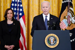 Vice President Kamala Harris listens as President Joe Biden speaks in the East Room of the White House.