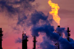 In this Dec.4, 2018 file photo a flame emits from a chimney at the BASF chemical company in Ludwigshafen, Germany.