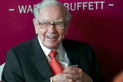 In this May 5, 2019, file photo Warren Buffett, Chairman and CEO of Berkshire Hathaway, smiles as he plays bridge following the annual Berkshire Hathaway shareholders meeting in Omaha, Neb. Buffett will spend Saturday afternoon fielding questions at Berkshire Hathaway's annual meeting, which is being held virtually.