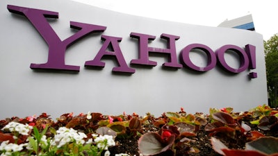 The Yahoo logo is displayed outside of offices in Santa Clara, Calif., in this Monday, April 18, 2011, file photo. Verizon is selling the segment of its business that includes Yahoo and AOL to private equity firm Apollo Global Management in a $5 billion deal. Verizon said Monday, May 3, 2021, that it will keep a 10% stake in the new company, which will be called Yahoo.