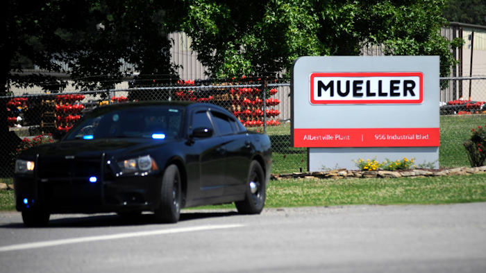 A police car guards the entrance to a Mueller Co. fire hydrant plant, Albertville, Ala., June 15, 2021.