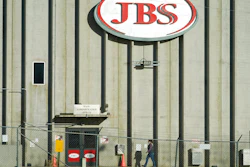 In this Oct. 12, 2020 photo, a worker heads into the JBS meatpacking plant in Greeley, Colo.