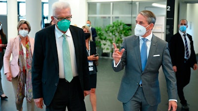 The Governor of Baden-Wuerttemberg, Winfried Kretschmann, front left, and Martin Jetter, front right, CEO of IBM Europe, attend the official inauguration of the first commercially used quantum computer in Europe, Ehningen, Germany, June 15, 2021.