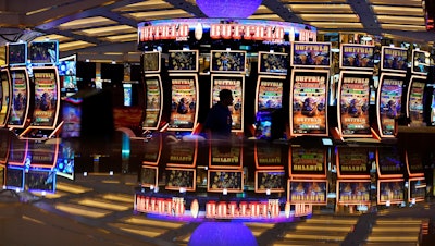 A person walks through a casino area ahead of the opening of Resorts World Las Vegas, June 23, 2021.