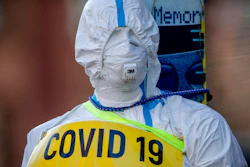 In this March 7, 2021 file photo an advertising figure for Covid-19 rapid test stands in front of a small test center in Frankfurt, Germany.