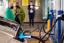 In this Thursday, April 22, 2021 file photo, White House climate adviser Gina McCarthy, left, talks with EVgo Chief Executive Officer Cathy Zoi, before the start of an event near an EVgo electric car charging station at Union Station in Washington. If the auto industry is to succeed in its bet that electric vehicles will soon dominate the roads, it will need to overcome a big reason why many people are still avoiding them: Fear of running out of juice between Point A and Point B.
