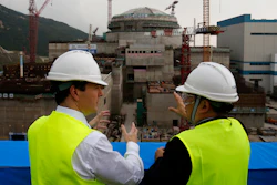 In this Oct. 17, 2013, file photo, then British Chancellor of the Exchequer George Osborne, left, chats with Taishan Nuclear Power Joint Venture Co. Ltd. General Manager Guo Liming as he inspects a nuclear reactor under construction at the nuclear power plant in Taishan, southeastern China's Guangdong province.