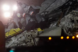 Rescue workers remove a body from the rubble where a wing of a 12-story beachfront condo building collapsed, Thursday, June 24, 2021, in the Surfside area of Miami.