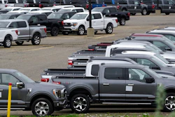Ford pickup trucks built lacking computer chips are shown in parking lot storage in Dearborn, Mich., Tuesday, May 4, 2021. Automakers are cutting production as they grapple with a global shortage of computer chips, and that's making dealers nervous.