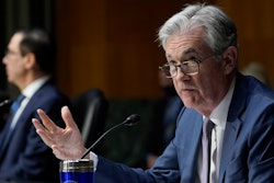 Federal Reserve Chairman Jerome Powell, right, testifies before the Senate Banking Committee on Capitol Hill in Washington, Tuesday, Dec. 1, 2020. The economy is growing at a healthy clip, and that has accelerated inflation, Federal Reserve Chair Jerome Powell says.