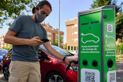 A man charges his electric car at an electrical charging point in Rivas Vaciamadrid, Spain, Tuesday, June 15, 2021. Spain is Europe's second-leading car maker but it is lagging behind when it comes to electric cars, a situation that the government aims to change by using around five billion euros of the EU pandemic recovery funds to kickstart the electric car industry.