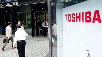 Shareholders arrive for Toshiba's general meeting of shareholders in Tokyo Friday, June 25, 2021. Battered Japanese nuclear and electronics giant Toshiba Corp. faced off with shareholders Friday, seeking to shake off serious questions about governance at the once revered brand.