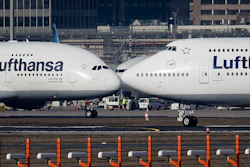 In this Feb. 14, 2019 photo, an Airbus A380, left, and a Boeing 747, both from Lufthansa airline pass each other at the airport in Frankfurt, Germany.