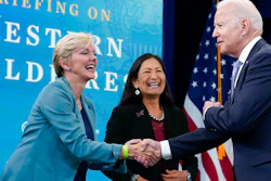 President Joe Biden, right, greets Energy Secretary Jennifer Granholm, left, and Interior Secretary Deb Haaland, center, before the start of an event in Washington, June 30, 2021.