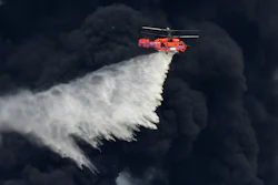 A helicopter drops a fire-retardant in a massive factory fire in Samut Prakan province, Thailand, Monday, July 5, 2021. A massive explosion at a factory on the outskirts of Bangkok has shaken an airport terminal serving Thailand’s capital, damaged homes in the surrounding neighborhood, and prompted the evacuation of a wide area over fears of poisonous fumes from burning chemicals and the possibility of additional denotations.