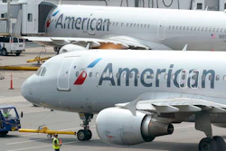 American Airlines passenger jets prepare for departure, Wednesday, July 21, 2021, near a terminal at Boston Logan International Airport, in Boston. American Airlines is planning to invest in a small South American budget airline as part of a deal that will include selling seats on each other's flights. American announced the proposed deal with JetSmart on Thursday, July 29.