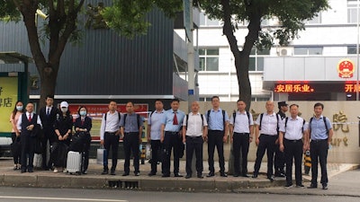 In this photo released by the defendants legal team, a team of lawyers for defendants on trial that included prominent Chinese pig farmer Sun Dawu stand outside the courthouse in Gaobeidian, in Northern China's Hebei province on Friday, 16 July 2021. The prominent Chinese pig farmer who was detained after praising lawyers during a crackdown on legal activists by President Xi Jinping's government went on trial Thursday, July 15, 2021 on charges including fighting with police and organizing a protest, defense lawyers said.
