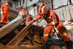 In this photo released by Xinhua News Agency, rescuers search for survivors at a collapsed hotel in Suzhou in eastern China's Jiangsu Province, Monday, July 12, 2021.