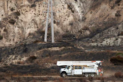 In this Oct. 15, 2019, file photo, SoCal Edison trucks arrive at the site of a transformer tower in Sylmar, Calif., suspected of being responsible for starting the Saddleridge Fire. Pacific Gas & Electric plans to bury 10,000 miles of its power lines in an effort to prevent its fraying grid from sparking wildfires when electrical equipment collides with millions of trees and other vegetation sprawling across its drought-stricken service.