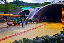 Rescuers build embankments to pump out water from a flooded tunnel in Zhuhai city in south China's Guangdong province Friday, July 16, 2021. Divers have been dispatched in the search for 14 workers missing since water flooded a tunnel under construction in southern China three days ago, authorities said Sunday, July 18, 2021.