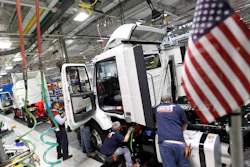 In a Jan. 6, 2011, file photo, workers install parts on a truck on the Volvo truck assembly line at the Volvo plant in Dublin, Va.