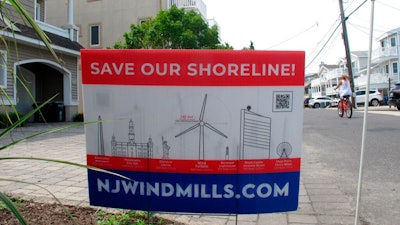 This July 8, 2021 photo shows a sign in Ocean City, N.J. urging opposition to offshore wind projects.
